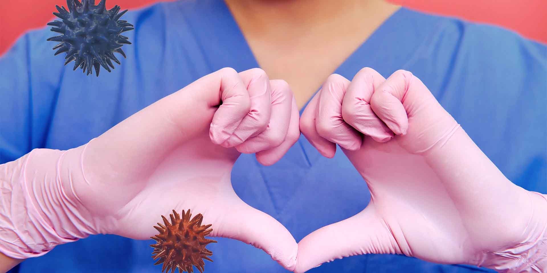 Nurse holding gloved hands in the shape of a heart